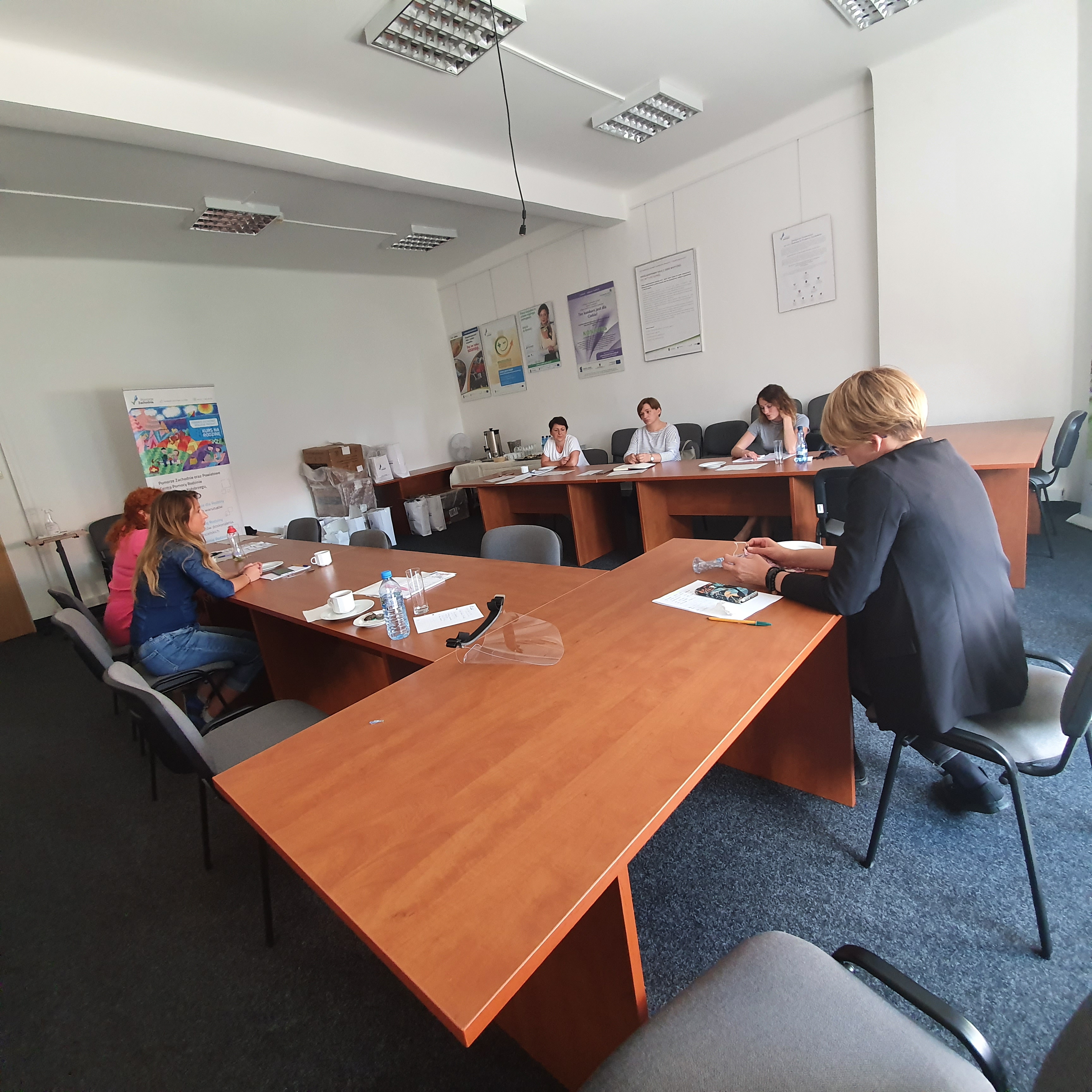 przedstawiciele lidera oraz parterów projektu na spotkaniu zespołu zachowujący odległość