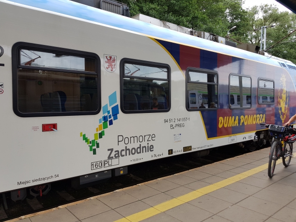 Wagon szynobusu z logo Pomorza Zachodniego, herbem województwa zachodniopomorskiego oraz napisem duma pomorza i herbem klubu sportowego pogoń szczecin