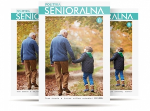 Pogodna jesień, dziadek z wnukiem spacerują ścieżką w parku, trzymają się za ręce, rozmawiają,